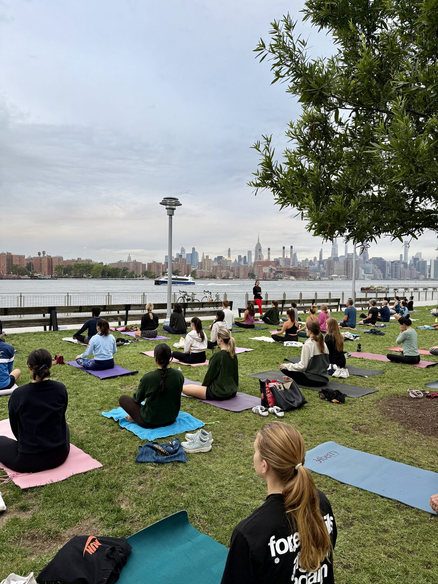 Outdoor group yoga with the New York City skyline